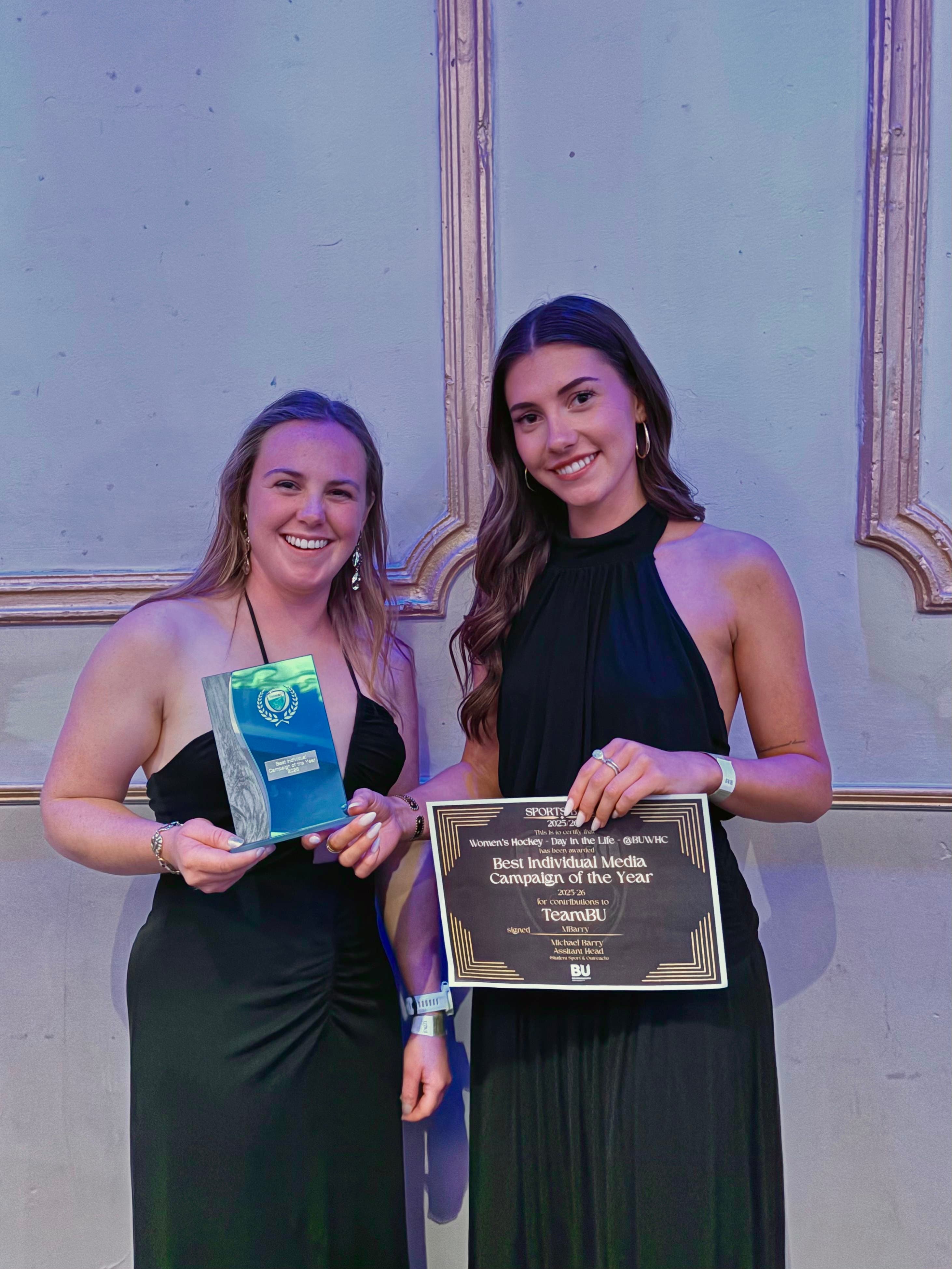 Megan Farrer and Polly Cranfield holding the Best Individual Media Campaign of the Year trophy and certificate at the Bournemouth University Sports Ball